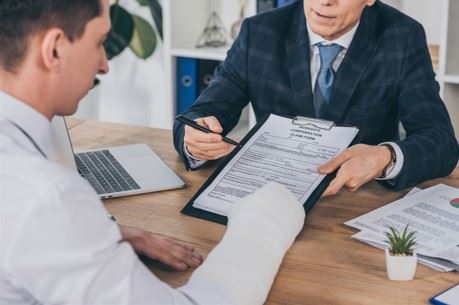injured worker talking to employer after workers comp claim is denied