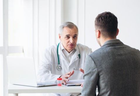 workers comp doctor talking to hurt employee
